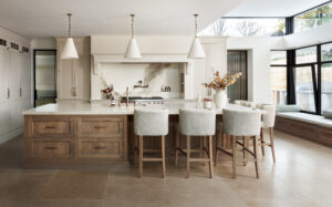 Bespoke cream kitchen with island, pendant lighting and skylight, viewed from the dining area, handmade by Woodale Designs in Ireland.