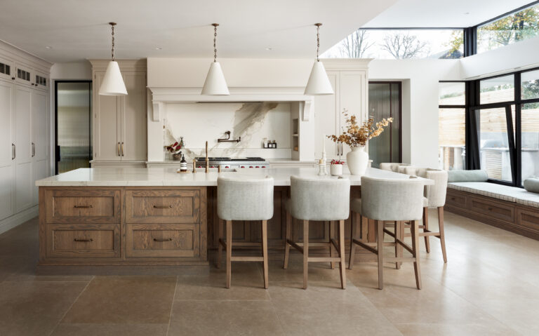 Bespoke cream kitchen with island, pendant lighting and skylight, viewed from the dining area, handmade by Woodale Designs in Ireland.